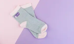Striped socks with purple iron on-label reading 'Stella'