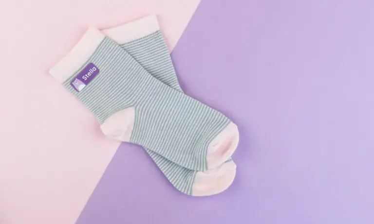 Striped socks with purple iron on-label reading 'Stella'
