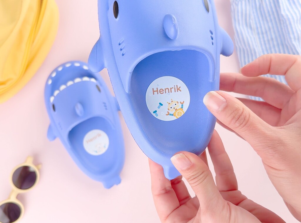 Blue kids’ shoes with personalized large name labels inside