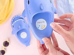 Blue kids’ shoes with personalized large name labels inside
